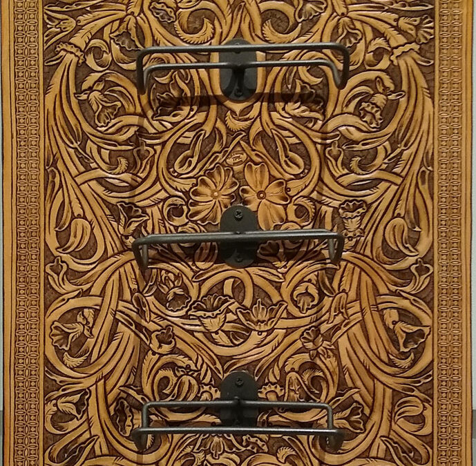 Tyler-Krause-Flower-Carved-Wine-Display-Leather-21×15-1650